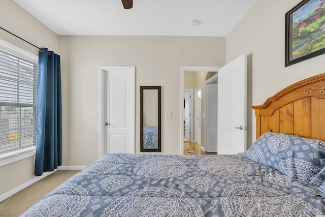 bedroom featuring light carpet, ceiling fan, and baseboards