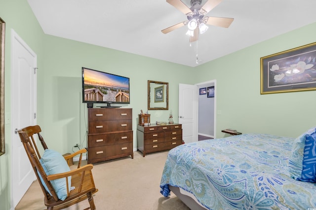 bedroom with a ceiling fan and light carpet