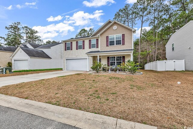 145 Bendick Ct, Little River, SC 29566 - traditional-style house with an attached garage, concrete driveway, fence, and a front lawn
