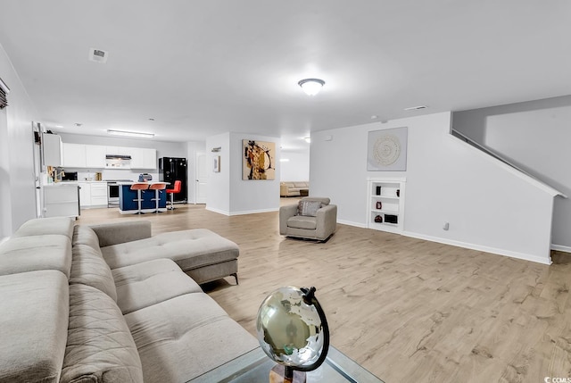 145 Bendick Ct, Little River, SC 29566 - living area featuring light wood-style floors, visible vents, and baseboards