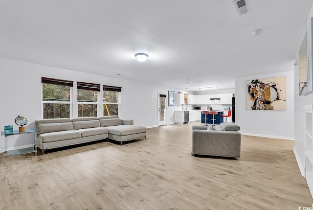 145 Bendick Ct, Little River, SC 29566 - living room with visible vents, baseboards, and light wood-style flooring