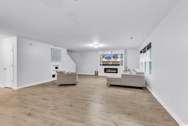 145 Bendick Ct, Little River, SC 29566 - living room with light wood-style floors, baseboards, and a glass covered fireplace