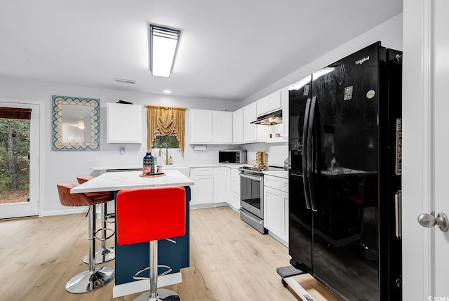 145 Bendick Ct, Little River, SC 29566 - kitchen with stainless steel appliances, under cabinet range hood, white cabinets, and light countertops