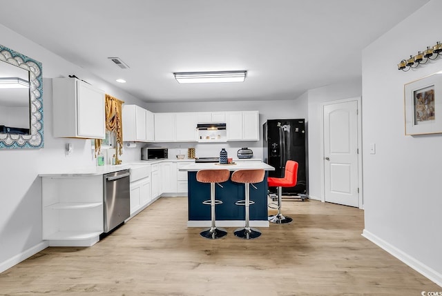 145 Bendick Ct, Little River, SC 29566 - kitchen featuring a kitchen bar, visible vents, white cabinets, light countertops, and stainless steel appliances