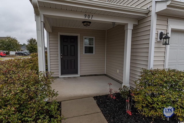 view of exterior entry with a porch