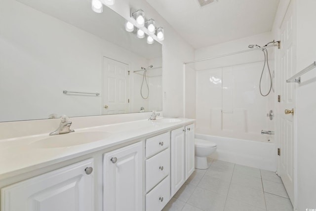 bathroom with double vanity, a sink, toilet, and tile patterned floors