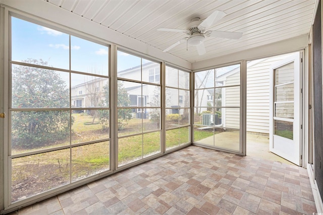 unfurnished sunroom with wooden ceiling, ceiling fan, and a wealth of natural light