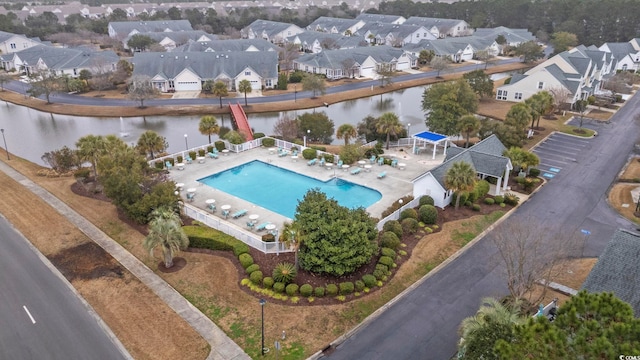 drone / aerial view featuring a residential view and a water view