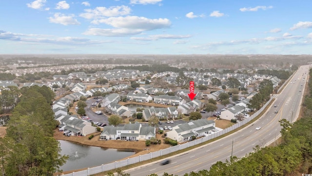 drone / aerial view with a water view and a residential view