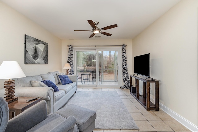 tiled living room with ceiling fan