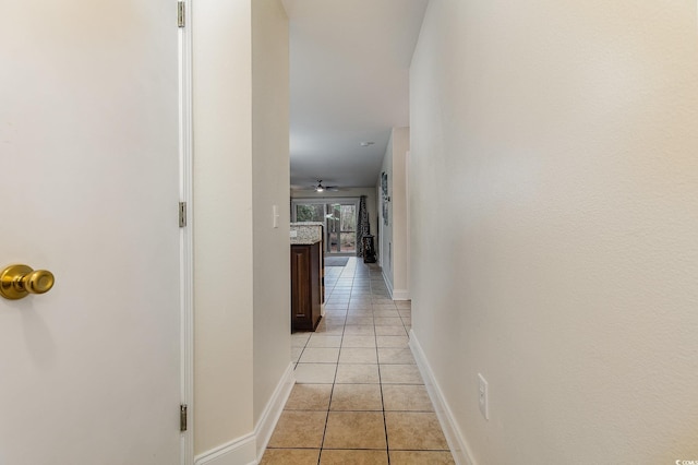 hall with light tile patterned floors