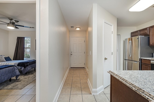 kitchen featuring light tile patterned floors and stainless steel refrigerator