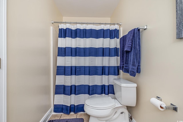 bathroom with tile patterned floors, toilet, and a shower with shower curtain