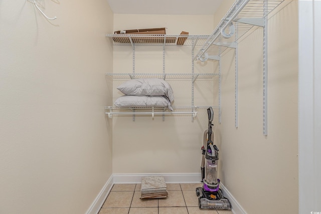 walk in closet with light tile patterned flooring