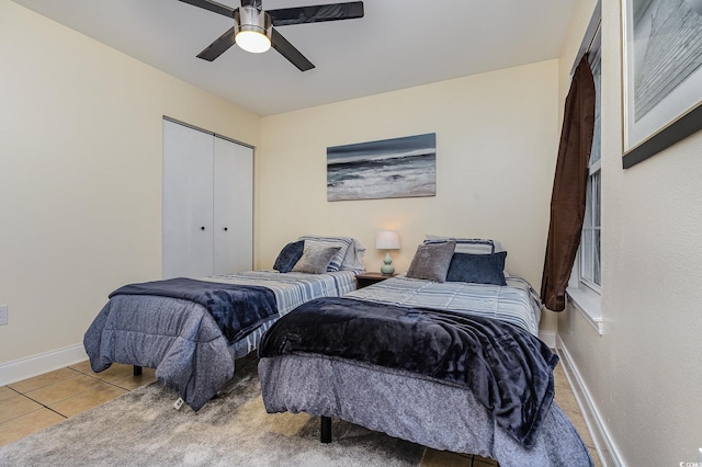 tiled bedroom featuring a closet and ceiling fan