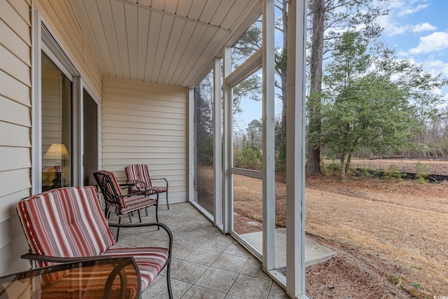 sunroom / solarium featuring wood ceiling