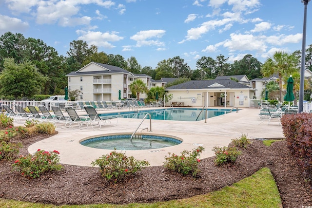 view of swimming pool with a community hot tub and a patio