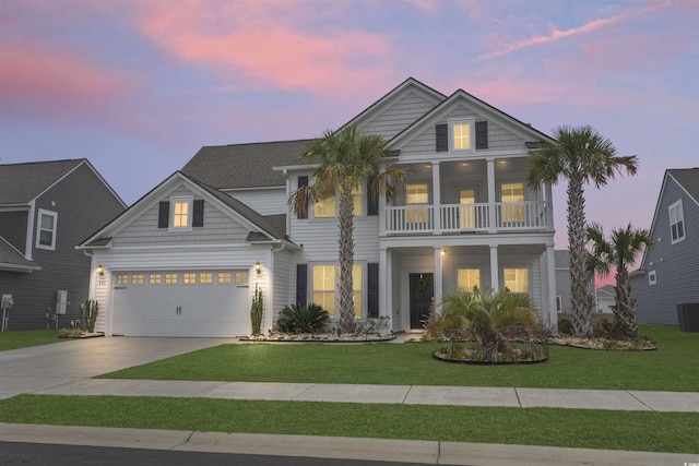 view of front facade featuring a garage, a yard, and a balcony