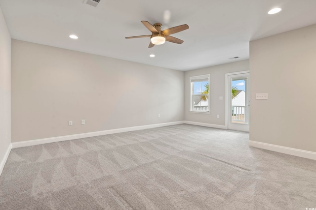 carpeted spare room with ceiling fan