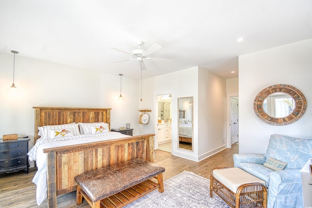 bedroom with hardwood / wood-style floors, ensuite bath, and ceiling fan