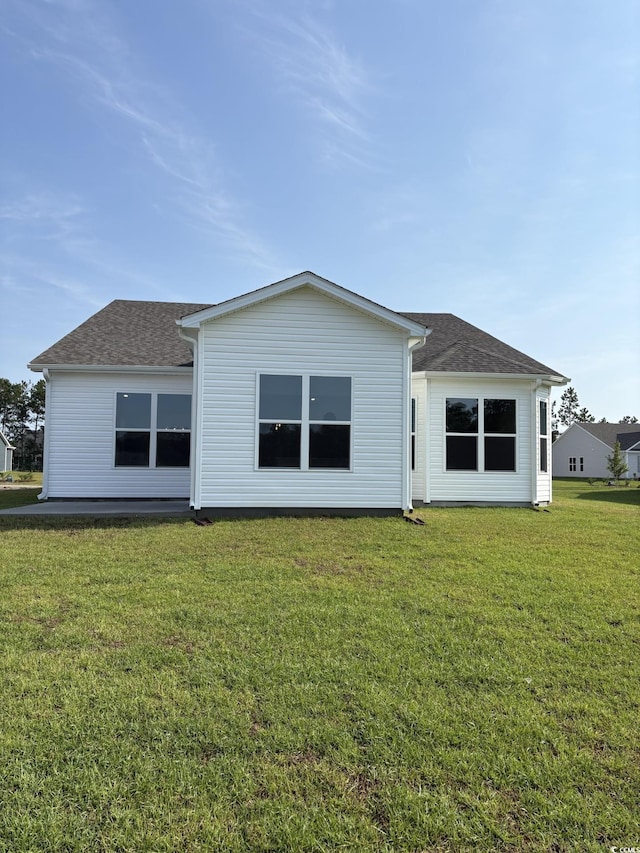 174 Glengrove Ln, Murrells Inlet, SC 29576 - rear view of property featuring a lawn and a shingled roof
