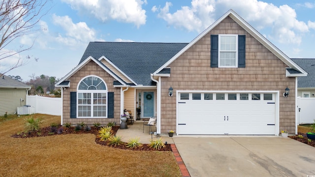 craftsman-style house featuring a garage and a front yard