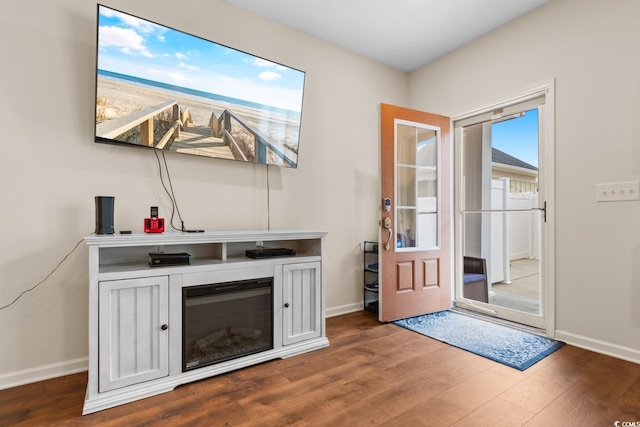 interior space featuring baseboards and wood finished floors