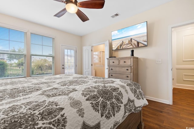 bedroom with ceiling fan, dark wood finished floors, visible vents, and baseboards