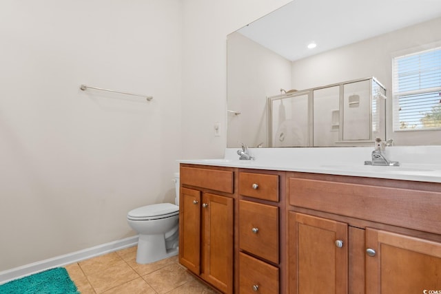 bathroom featuring double vanity, toilet, a sink, a shower stall, and tile patterned floors