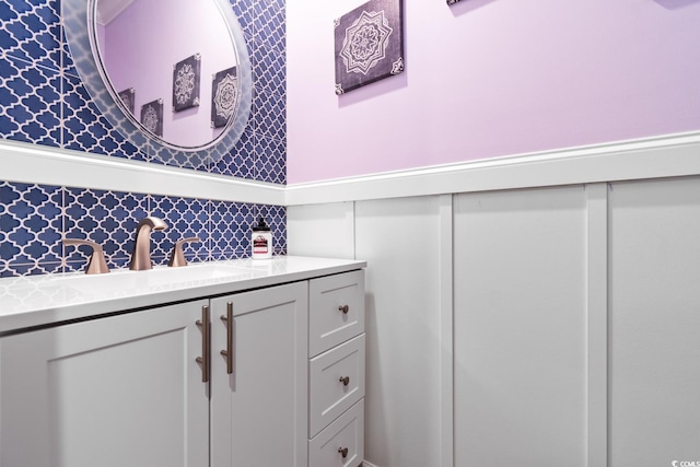 bathroom featuring wallpapered walls and vanity