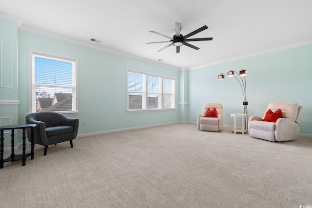 sitting room featuring carpet floors, a ceiling fan, visible vents, and crown molding