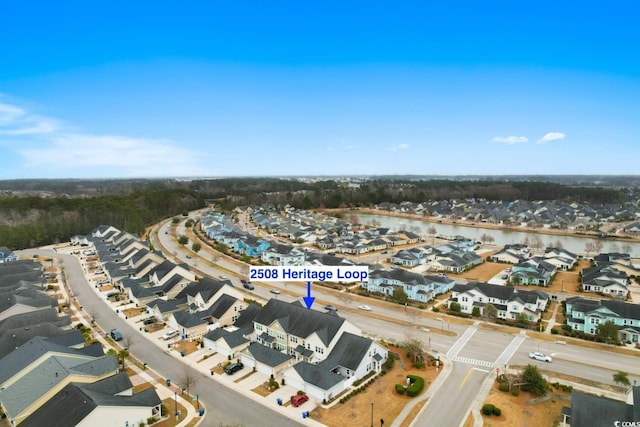 drone / aerial view featuring a water view and a residential view