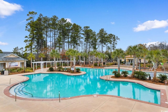 pool featuring a pergola and a patio