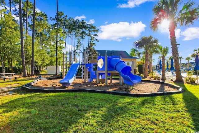 communal playground featuring a lawn