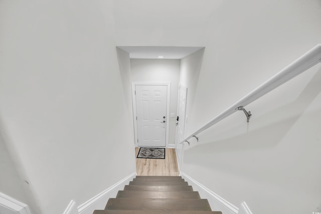 stairway featuring wood-type flooring