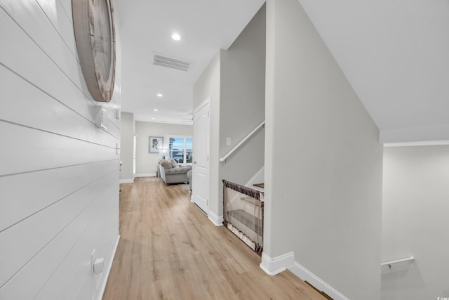 hallway with light hardwood / wood-style floors