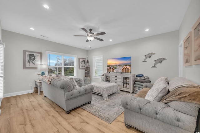 living room featuring ceiling fan and light wood-type flooring