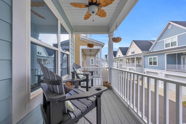 balcony with covered porch and ceiling fan