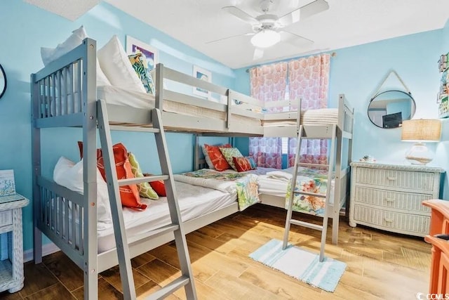 bedroom with ceiling fan and wood finished floors