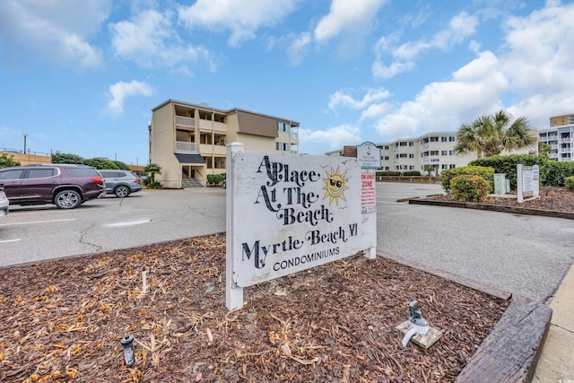 community sign with uncovered parking
