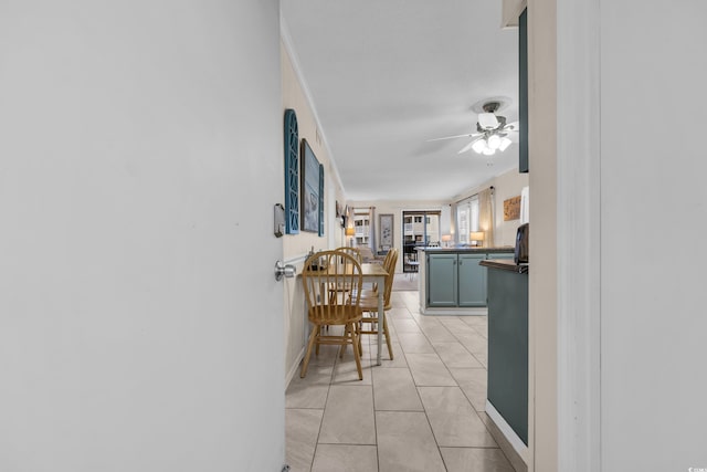 hallway with baseboards and light tile patterned floors