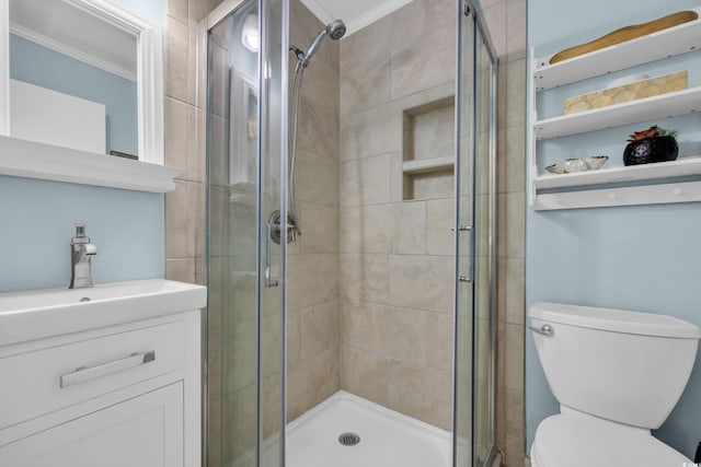 bathroom featuring crown molding, toilet, vanity, and a stall shower