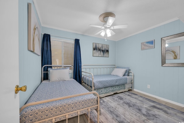 bedroom featuring ceiling fan, baseboards, and crown molding