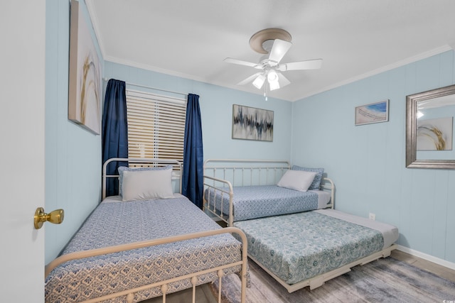 bedroom featuring baseboards, ceiling fan, and crown molding