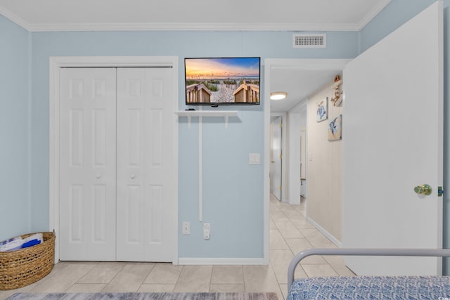 bedroom with visible vents, tile patterned flooring, a closet, and ornamental molding