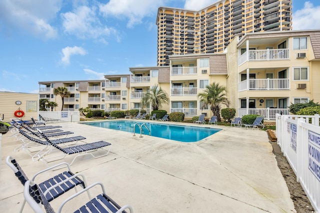 pool featuring a patio area and fence