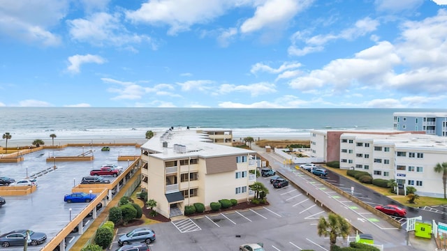 drone / aerial view featuring a beach view and a water view