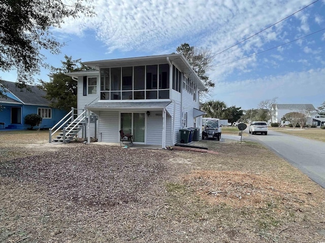 back of property with a sunroom