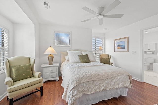 bedroom featuring dark hardwood / wood-style flooring, connected bathroom, and ceiling fan