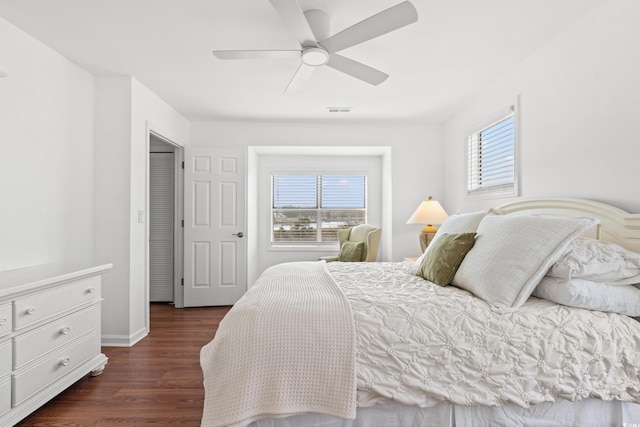 bedroom with ceiling fan and dark hardwood / wood-style flooring